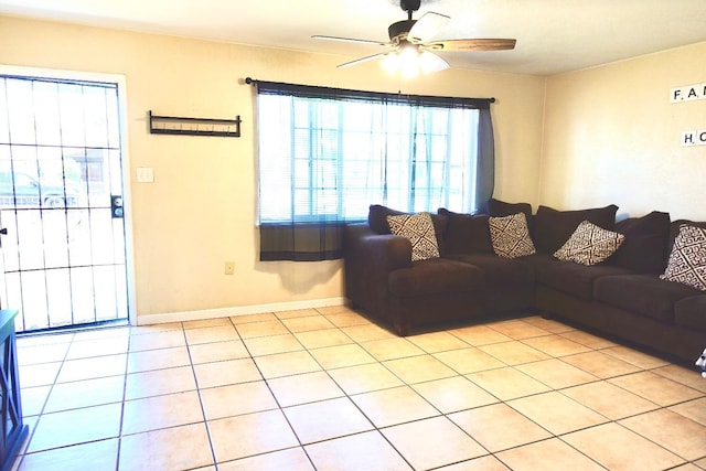 215 W Vine Ave, Visalia, CA 93291 - living area with baseboards, ceiling fan, and light tile patterned flooring