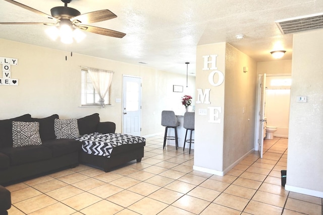215 W Vine Ave, Visalia, CA 93291 - living room with light tile patterned floors, baseboards, ceiling fan, and visible vents