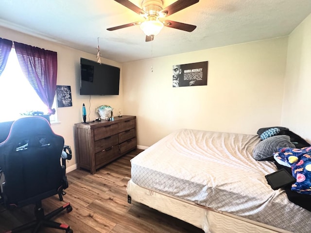 215 W Vine Ave, Visalia, CA 93291 - bedroom featuring baseboards, a ceiling fan, and wood finished floors