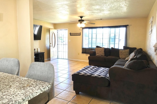 215 W Vine Ave, Visalia, CA 93291 - living room with baseboards, ceiling fan, light tile patterned floors, and a wealth of natural light