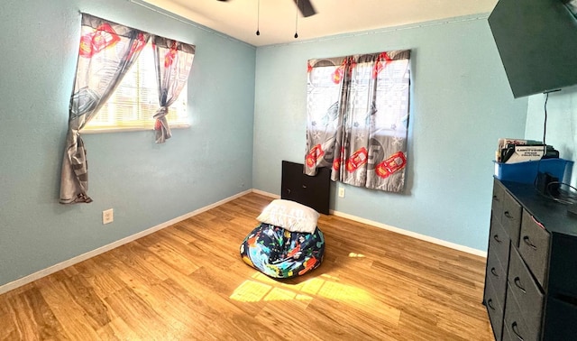 215 W Vine Ave, Visalia, CA 93291 - bedroom with baseboards, multiple windows, and wood finished floors
