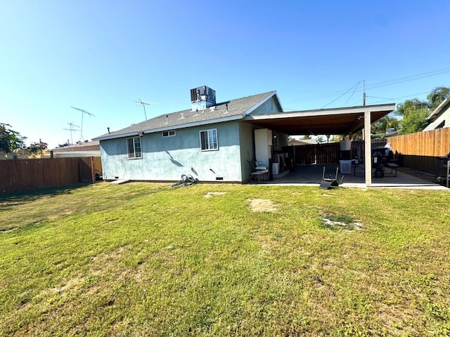 215 W Vine Ave, Visalia, CA 93291 - rear view of house with a yard, a fenced backyard, and stucco siding