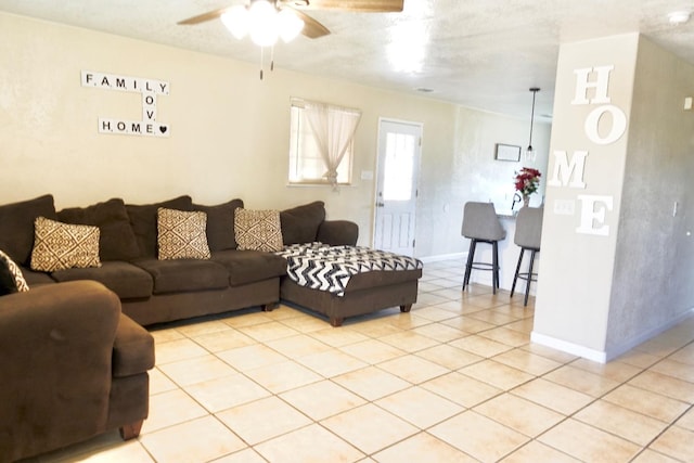 215 W Vine Ave, Visalia, CA 93291 - living area featuring a ceiling fan, baseboards, and light tile patterned floors
