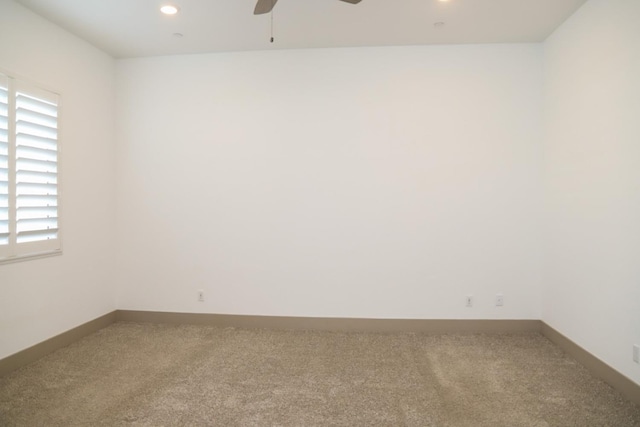 carpeted empty room featuring plenty of natural light, baseboards, and ceiling fan