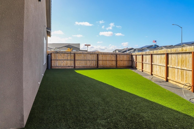 view of yard with a fenced backyard