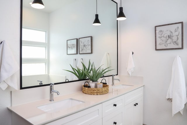 bathroom with a sink and double vanity