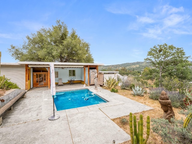 view of pool with a fenced in pool, an outdoor structure, and a patio area