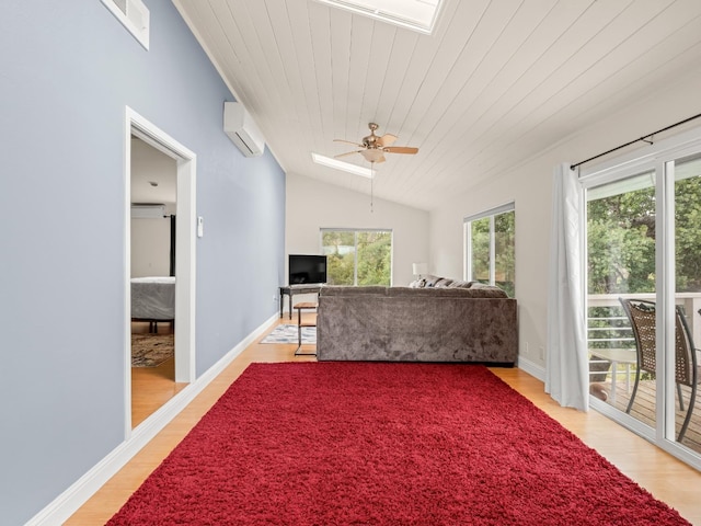 sunroom featuring a wall mounted air conditioner, a wall unit AC, and a skylight