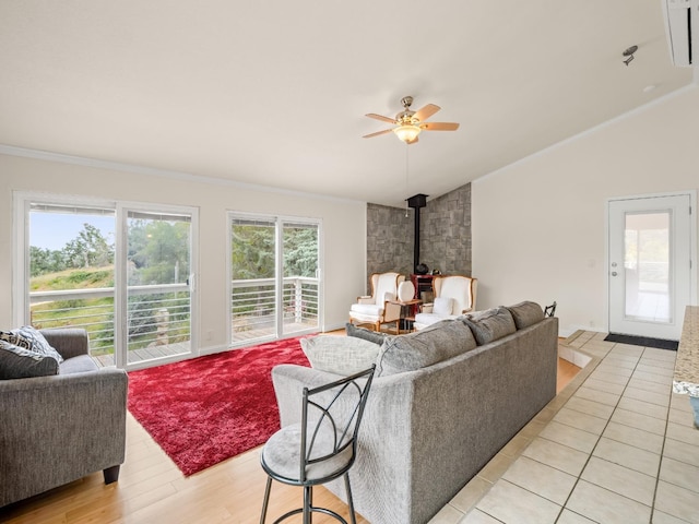 living room featuring a wood stove, a ceiling fan, lofted ceiling, and ornamental molding