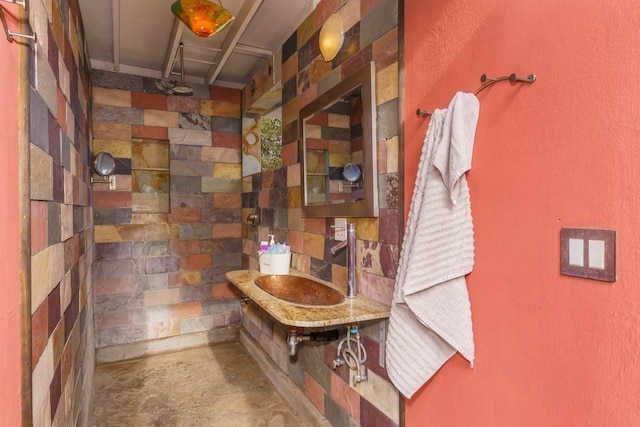 bathroom featuring a sink and unfinished concrete floors