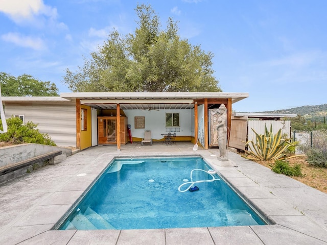 back of house with a patio, an outdoor pool, and fence