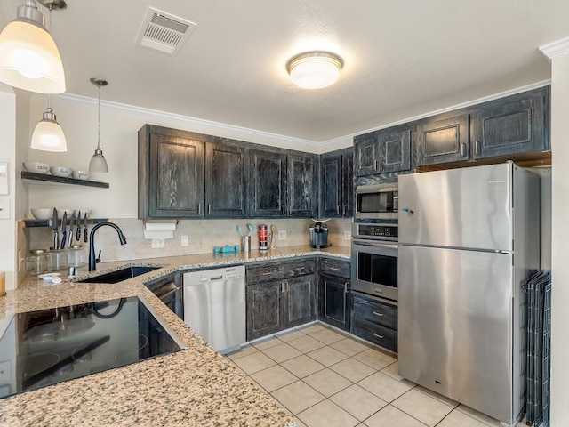 kitchen featuring visible vents, appliances with stainless steel finishes, light stone countertops, a sink, and light tile patterned floors