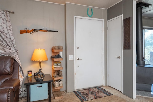 entrance foyer featuring a wood stove