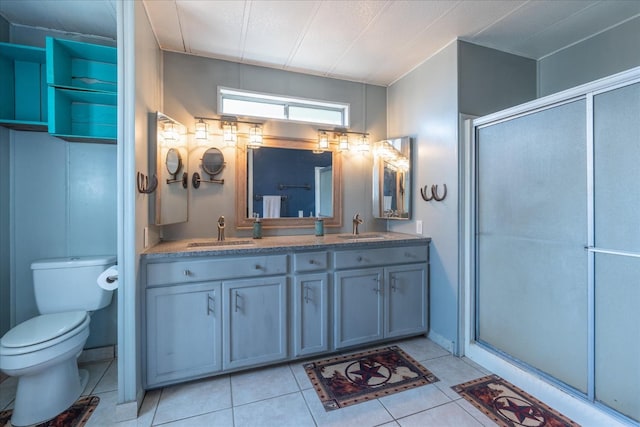 bathroom featuring a sink, a shower stall, and toilet