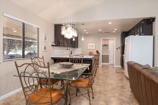 dining space with light tile patterned flooring, baseboards, recessed lighting, a notable chandelier, and vaulted ceiling