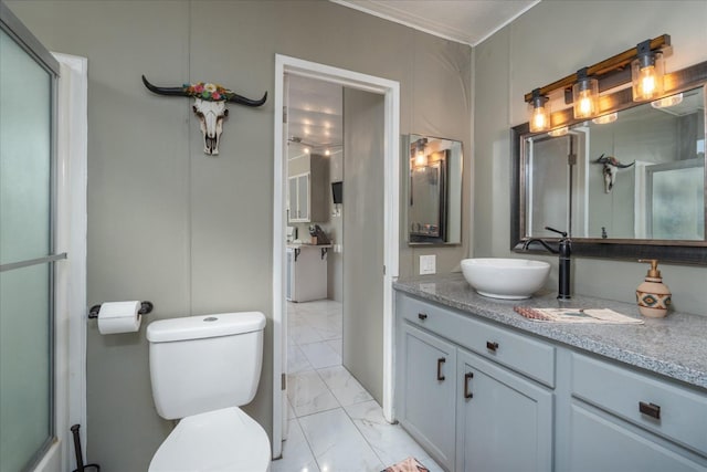 full bathroom featuring crown molding, a shower with shower door, vanity, toilet, and marble finish floor