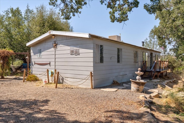 view of side of home with a wooden deck