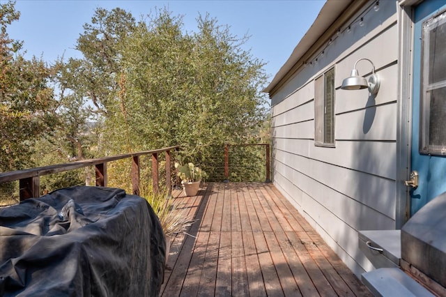 wooden terrace with a grill