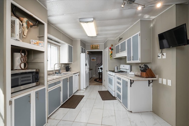 kitchen featuring marble finish floor, white appliances, light countertops, under cabinet range hood, and a sink