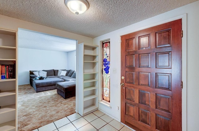 827 N Armstrong Ave, Clovis, CA 93611 - foyer entrance with light carpet, a textured ceiling, and light tile patterned flooring