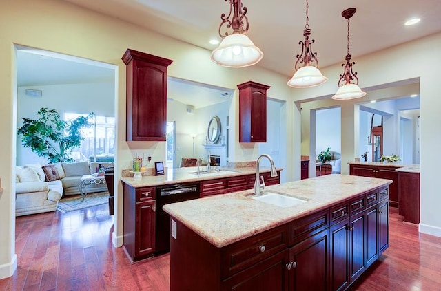 172 Omaha Ave, Clovis, CA 93619 - kitchen featuring dishwasher, a sink, reddish brown cabinets, a kitchen island with sink, and recessed lighting