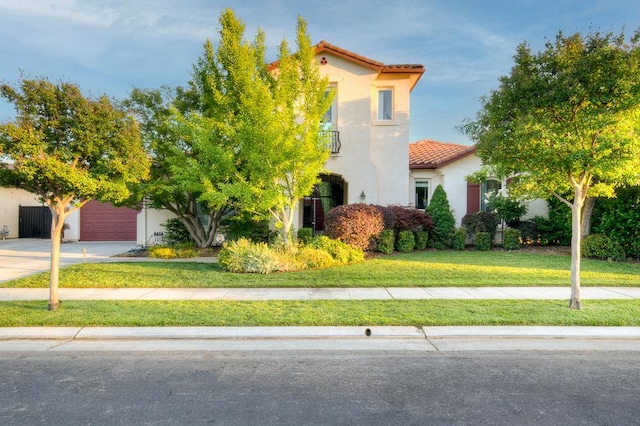 172 Omaha Ave, Clovis, CA 93619 - mediterranean / spanish house featuring a tile roof, stucco siding, driveway, a front yard, and an attached garage