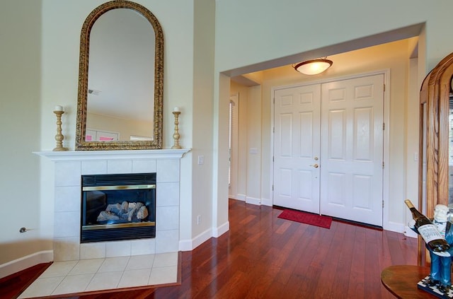 172 Omaha Ave, Clovis, CA 93619 - entrance foyer featuring wood finished floors, a tiled fireplace, and baseboards