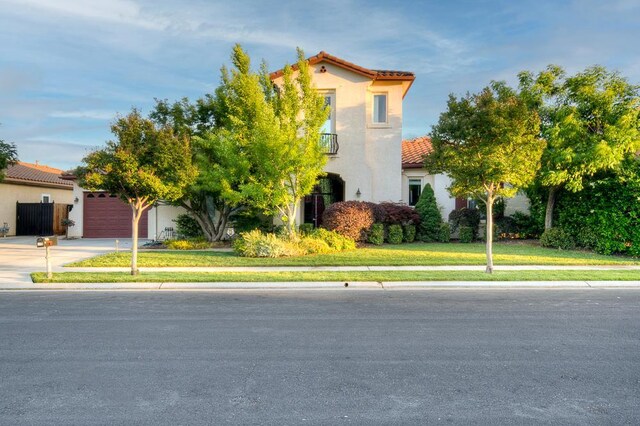 172 Omaha Ave, Clovis, CA 93619 - view of front of house featuring a tiled roof, a garage, driveway, stucco siding, and a front lawn