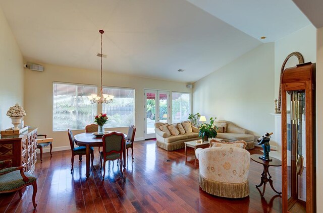 172 Omaha Ave, Clovis, CA 93619 - dining area featuring plenty of natural light, a chandelier, dark wood-style flooring, lofted ceiling, and baseboards