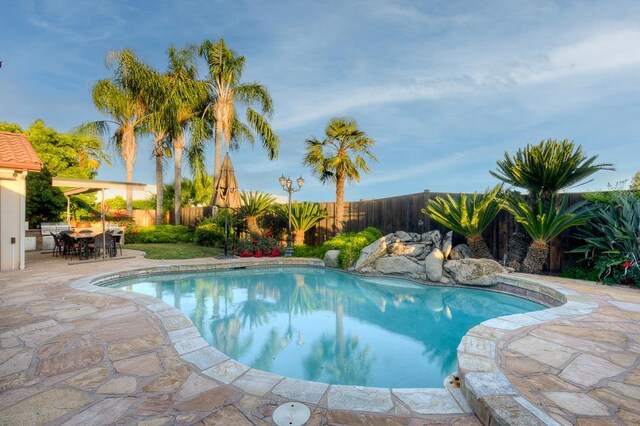 172 Omaha Ave, Clovis, CA 93619 - view of pool featuring a fenced backyard, a patio area, and outdoor dining area