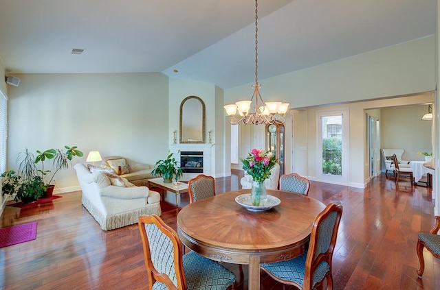 172 Omaha Ave, Clovis, CA 93619 - dining space featuring vaulted ceiling, a chandelier, a tile fireplace, baseboards, and wood finished floors