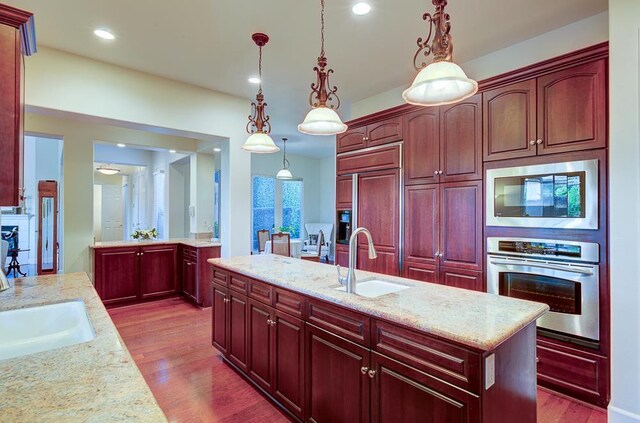 172 Omaha Ave, Clovis, CA 93619 - kitchen with built in appliances, a sink, dark brown cabinets, dark wood finished floors, and recessed lighting
