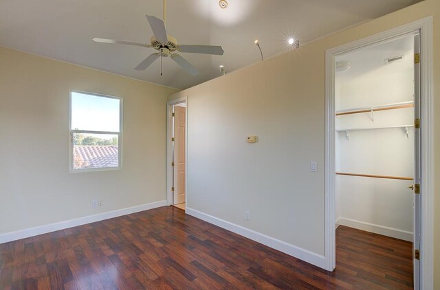 172 Omaha Ave, Clovis, CA 93619 - unfurnished bedroom with wood finished floors, a closet, a spacious closet, baseboards, and a ceiling fan