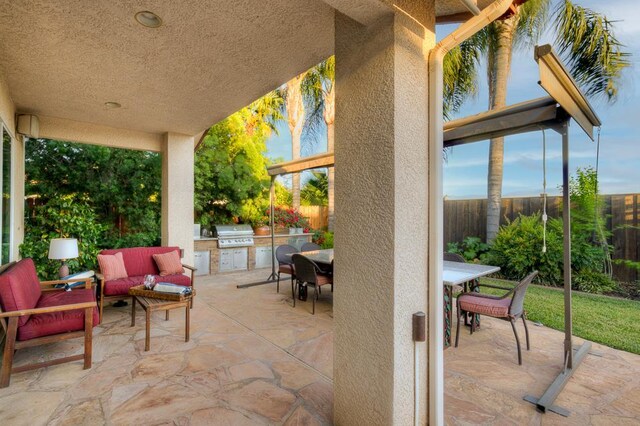 172 Omaha Ave, Clovis, CA 93619 - view of patio with exterior kitchen, a grill, a fenced backyard, outdoor dining area, and an outdoor living space