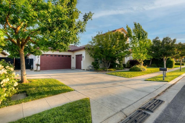 172 Omaha Ave, Clovis, CA 93619 - view of front of home with driveway, a garage, a tiled roof, and stucco siding