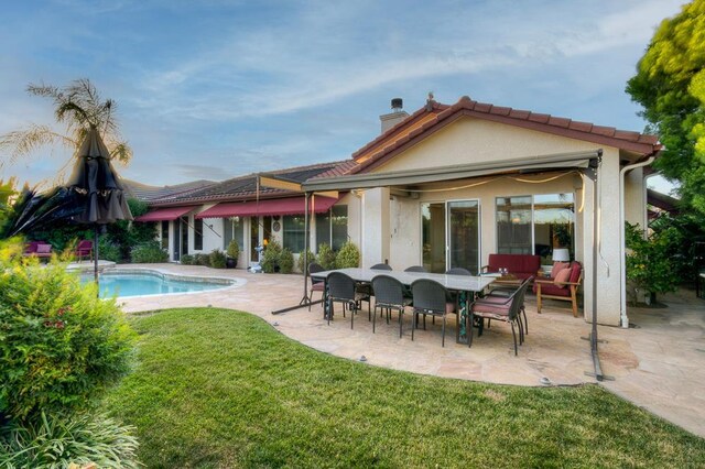 172 Omaha Ave, Clovis, CA 93619 - back of house featuring a patio area, a chimney, a yard, an outdoor pool, and stucco siding