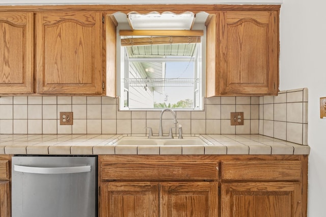 4462 N Manila Ave, Fresno, CA 93727 - kitchen featuring stainless steel dishwasher, decorative backsplash, tile countertops, and brown cabinets