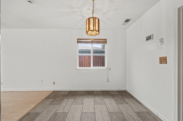 4462 N Manila Ave, Fresno, CA 93727 - empty room with a chandelier and wood finished floors
