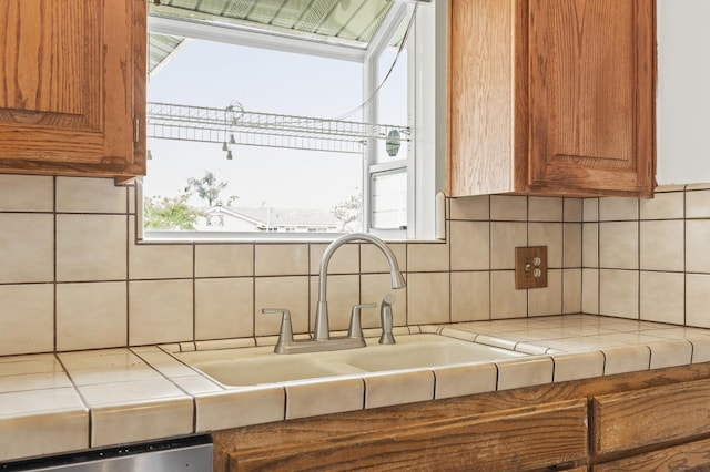 4462 N Manila Ave, Fresno, CA 93727 - kitchen with backsplash, brown cabinets, and tile countertops