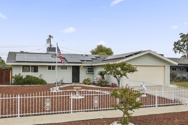 4462 N Manila Ave, Fresno, CA 93727 - ranch-style house with a fenced front yard, an attached garage, driveway, and roof mounted solar panels
