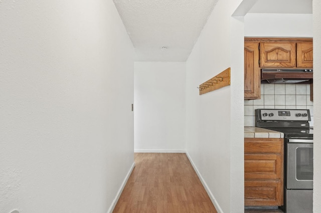 4462 N Manila Ave, Fresno, CA 93727 - hall with baseboards and light wood-type flooring