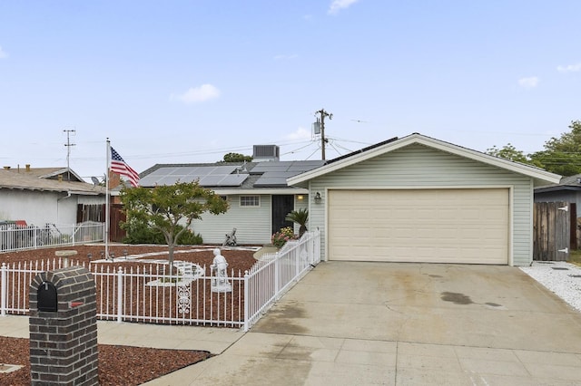 4462 N Manila Ave, Fresno, CA 93727 - single story home with a fenced front yard, solar panels, a garage, and concrete driveway