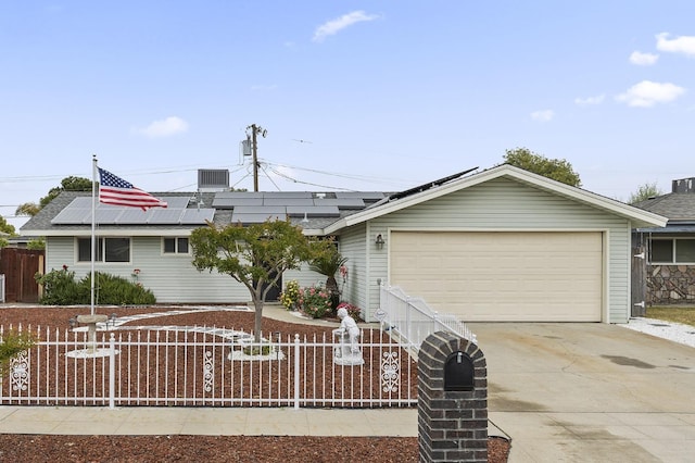 4462 N Manila Ave, Fresno, CA 93727 - single story home with a fenced front yard, a garage, solar panels, and concrete driveway