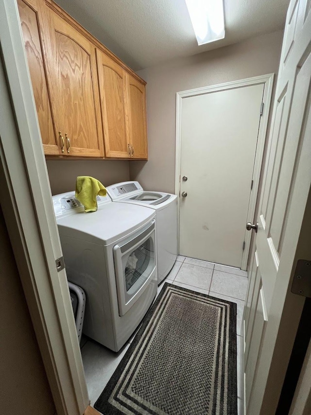 348 E Northridge, Dinuba, CA 93618 - clothes washing area featuring cabinet space, separate washer and dryer, a textured ceiling, and light tile patterned floors