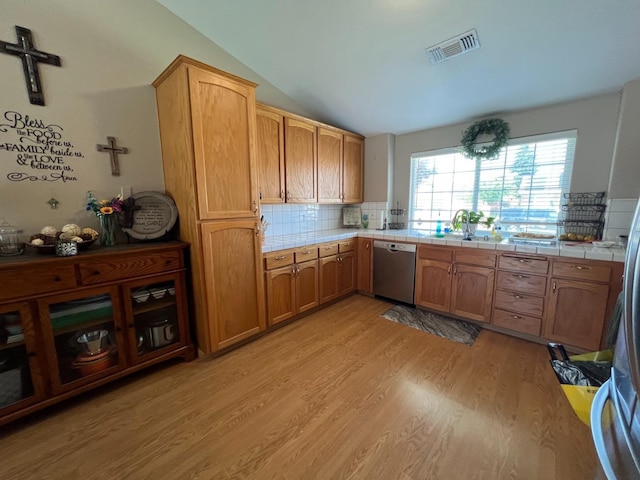 348 E Northridge, Dinuba, CA 93618 - kitchen featuring stainless steel dishwasher, visible vents, light wood-style floors, tile countertops, and vaulted ceiling