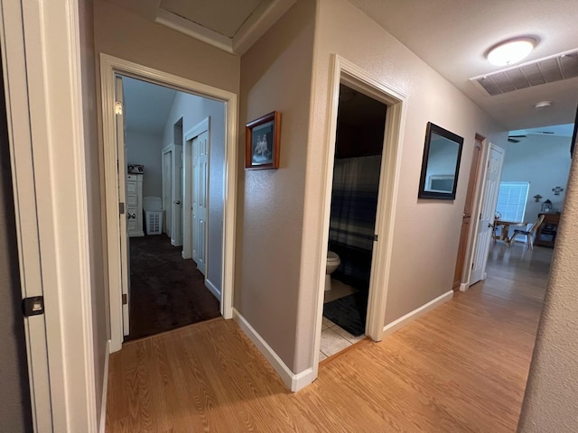 348 E Northridge, Dinuba, CA 93618 - hallway with baseboards, attic access, light wood finished floors, and visible vents