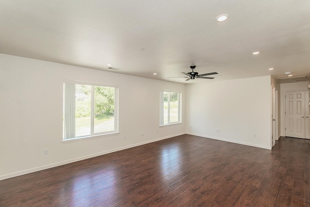 empty room featuring plenty of natural light, a ceiling fan, and baseboards