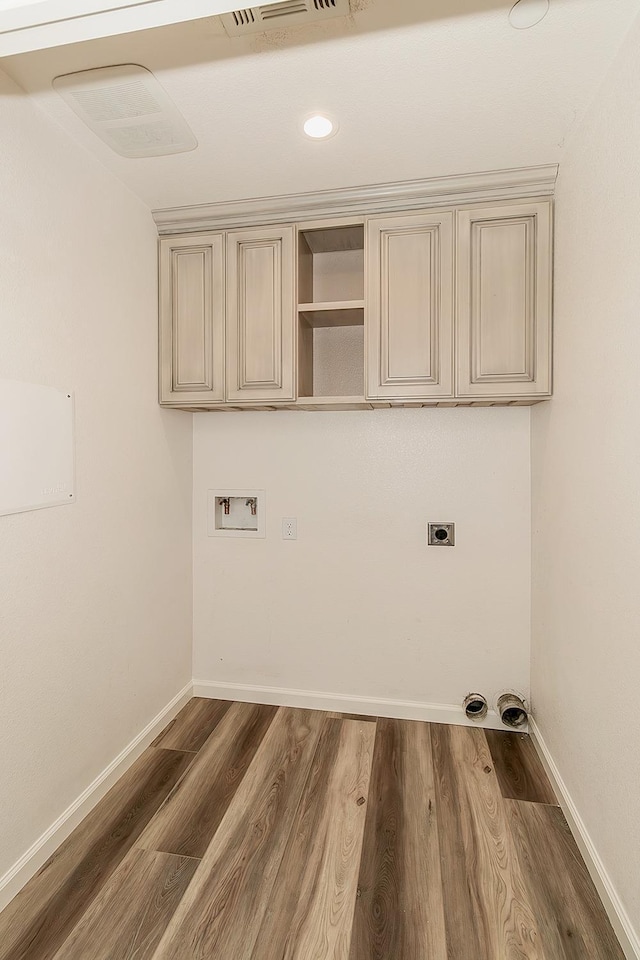 laundry room with electric dryer hookup, washer hookup, wood finished floors, and visible vents
