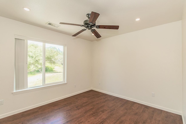 empty room with visible vents, recessed lighting, baseboards, and dark wood-style floors