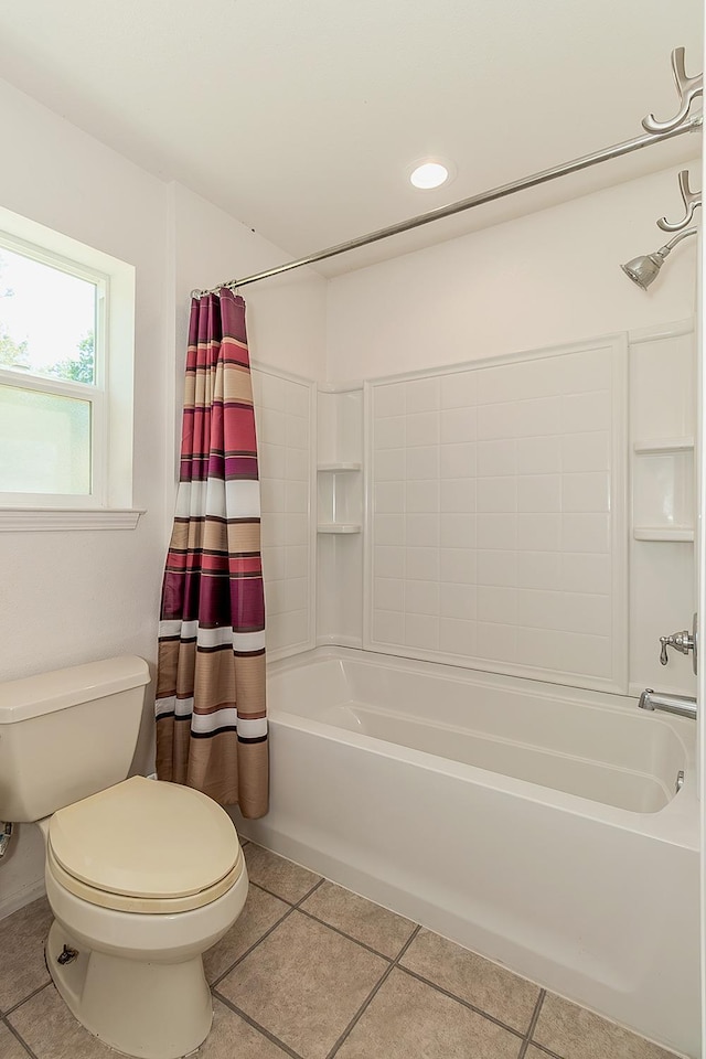 bathroom featuring tile patterned floors, shower / bath combo with shower curtain, and toilet